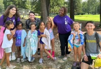 group photo of kids and camp counselors outside