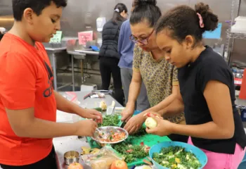 image of family cooking a meal during cooking class