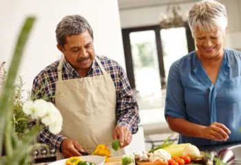 image of two older adults cooking