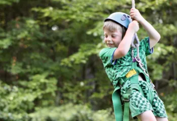 up close image of young boy ziplinging