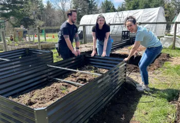 image of three volunteers working in the garden