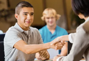 male teen shaking hands with employer