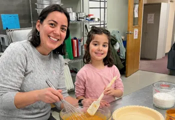 Mother and daughter making pumpkin pie at a MetroWest YMCA Family Dinner Night