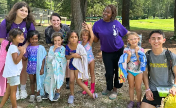 group photo of kids and camp counselors outside