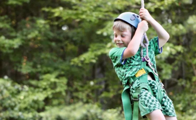 up close image of young boy ziplinging