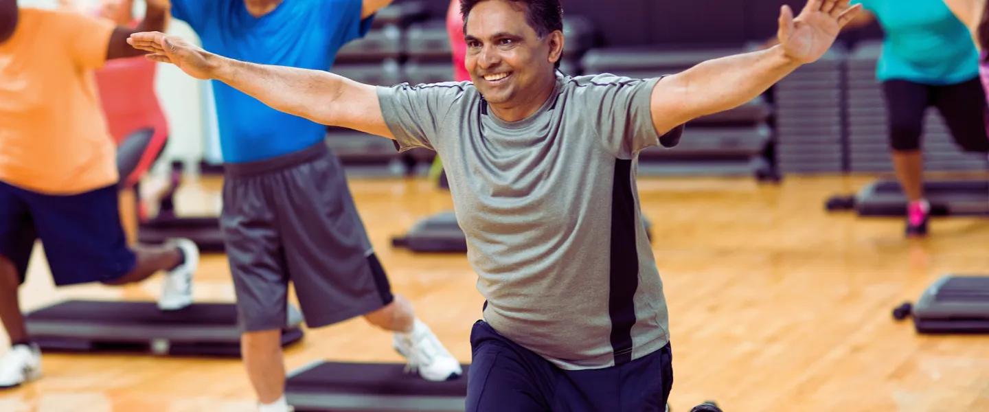 Group of all ages in a strength and weights group exercise class