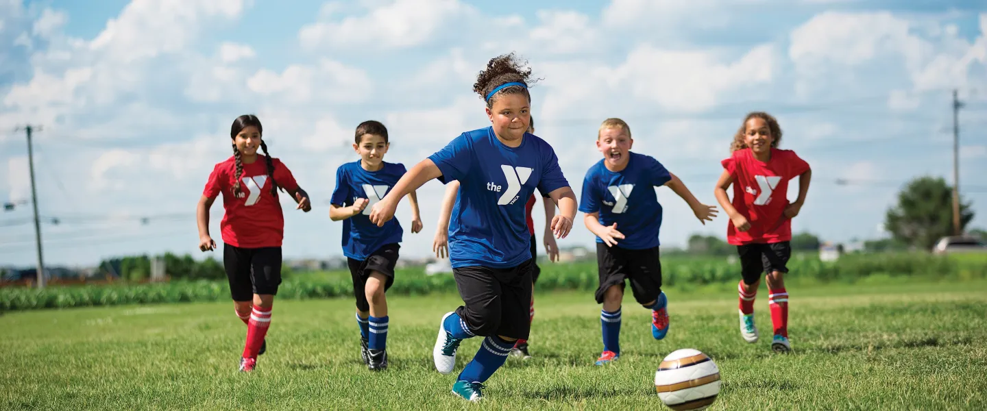 group of kids outside playing soccer