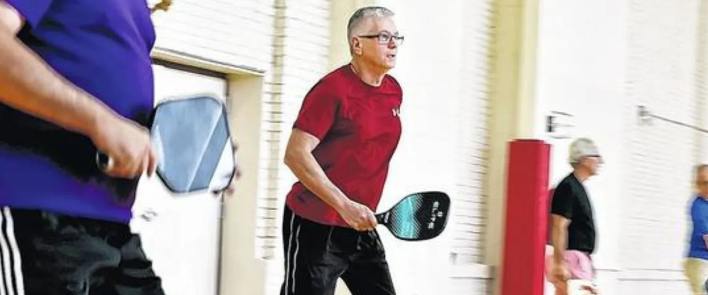 adult men playing indoor pickleball