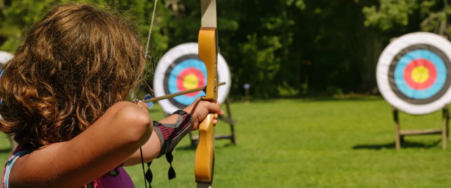 close-up of girl at archery range