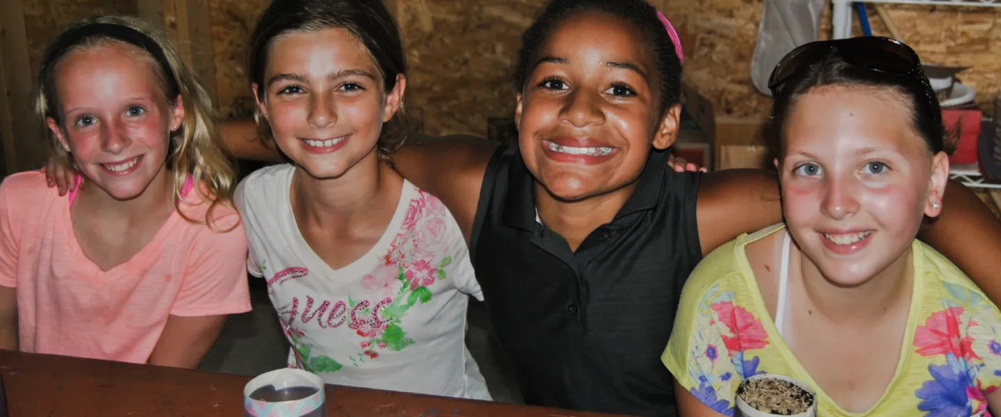 group of four girls smiling together