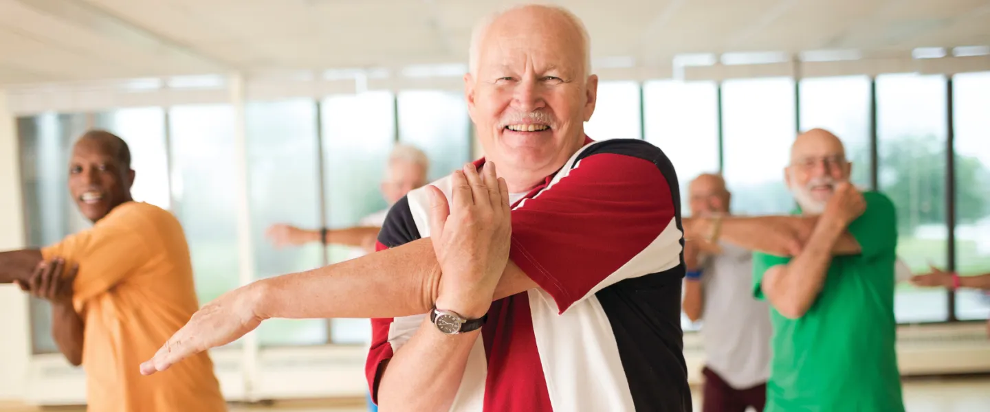 group of seniors stretching in wellness class