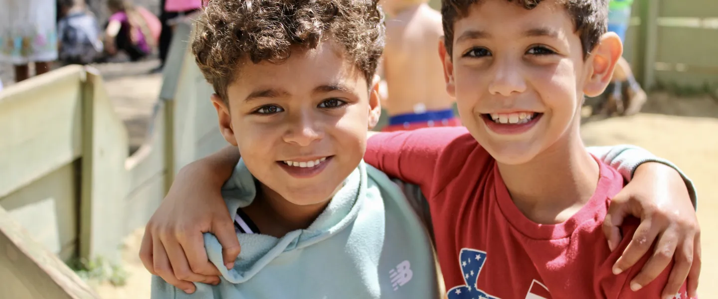 Smiling boys make friends at camp