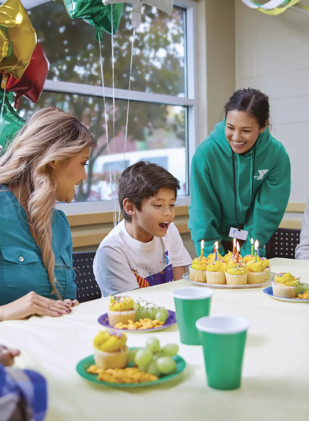 young boy blowing on birthday candles