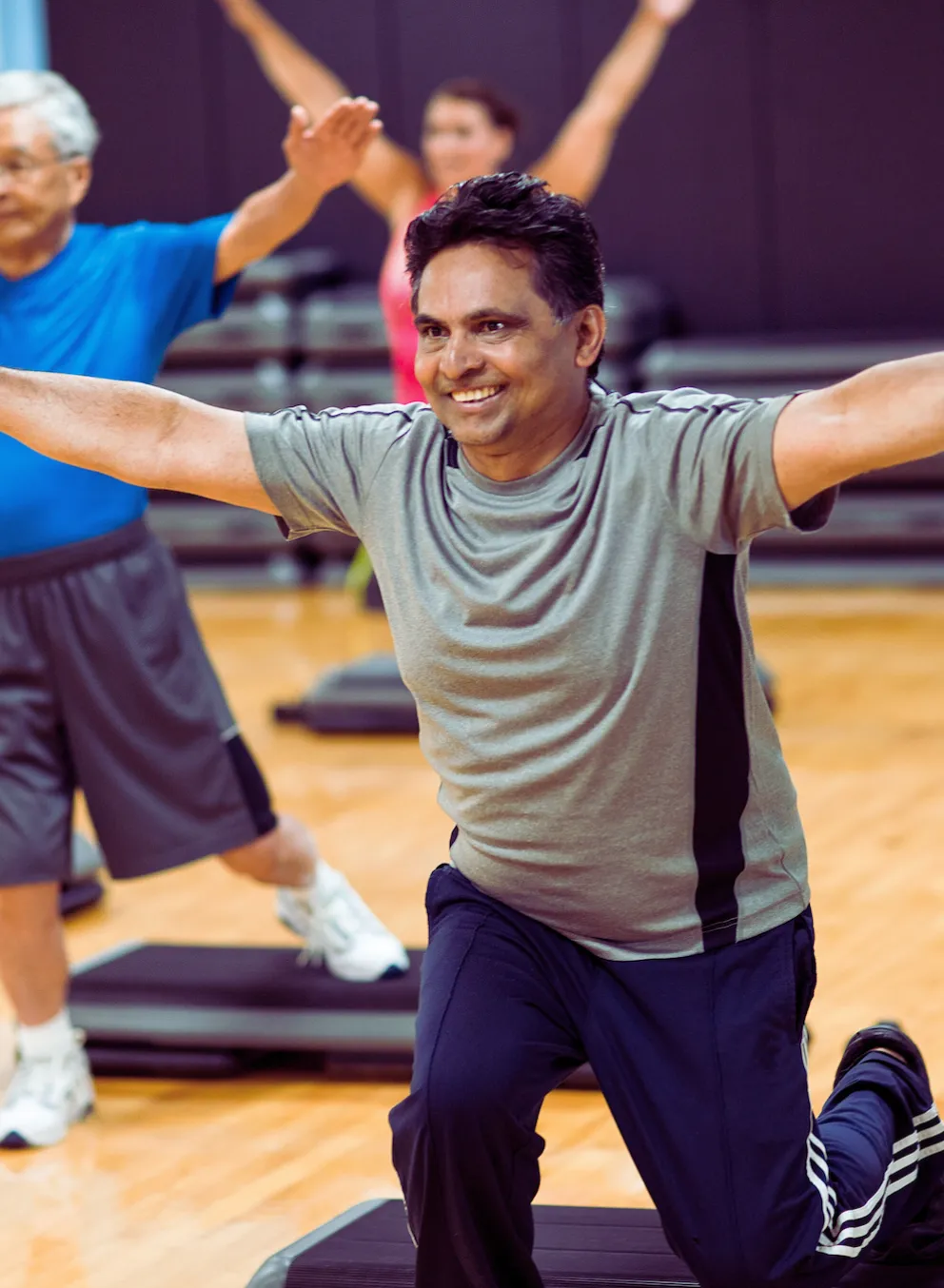 Group of all ages in a strength and weights group exercise class