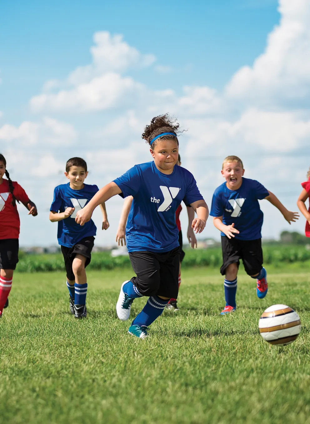 group of kids outside playing soccer