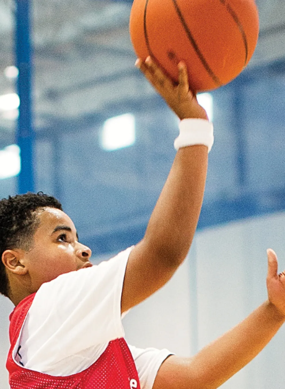 boy jumping to shoot a basketball