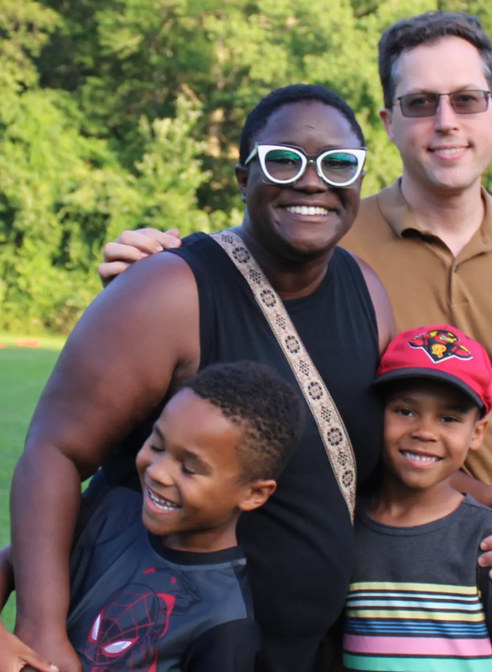 family of four smiling together