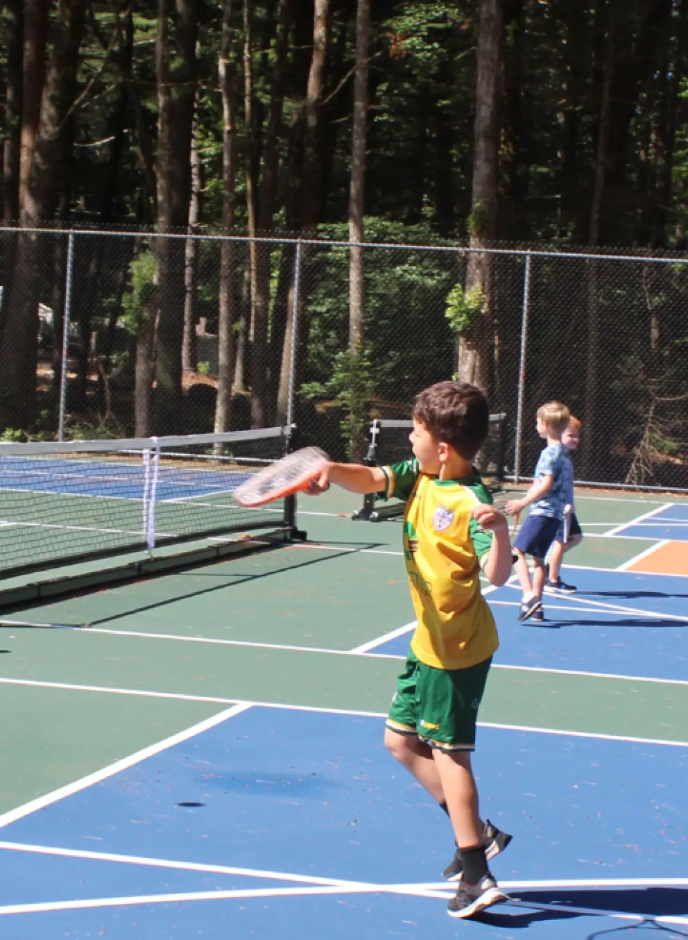 boy playing pickleball