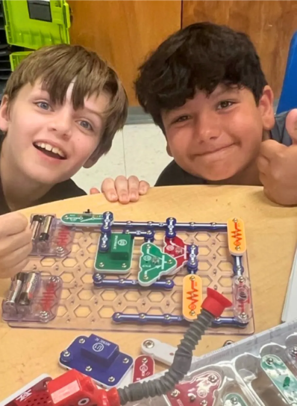 two boys showing off their project