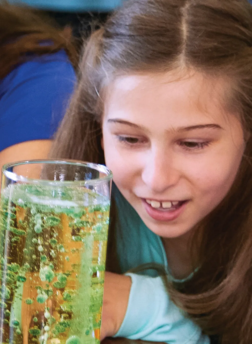 up close image of students looking at science experiment