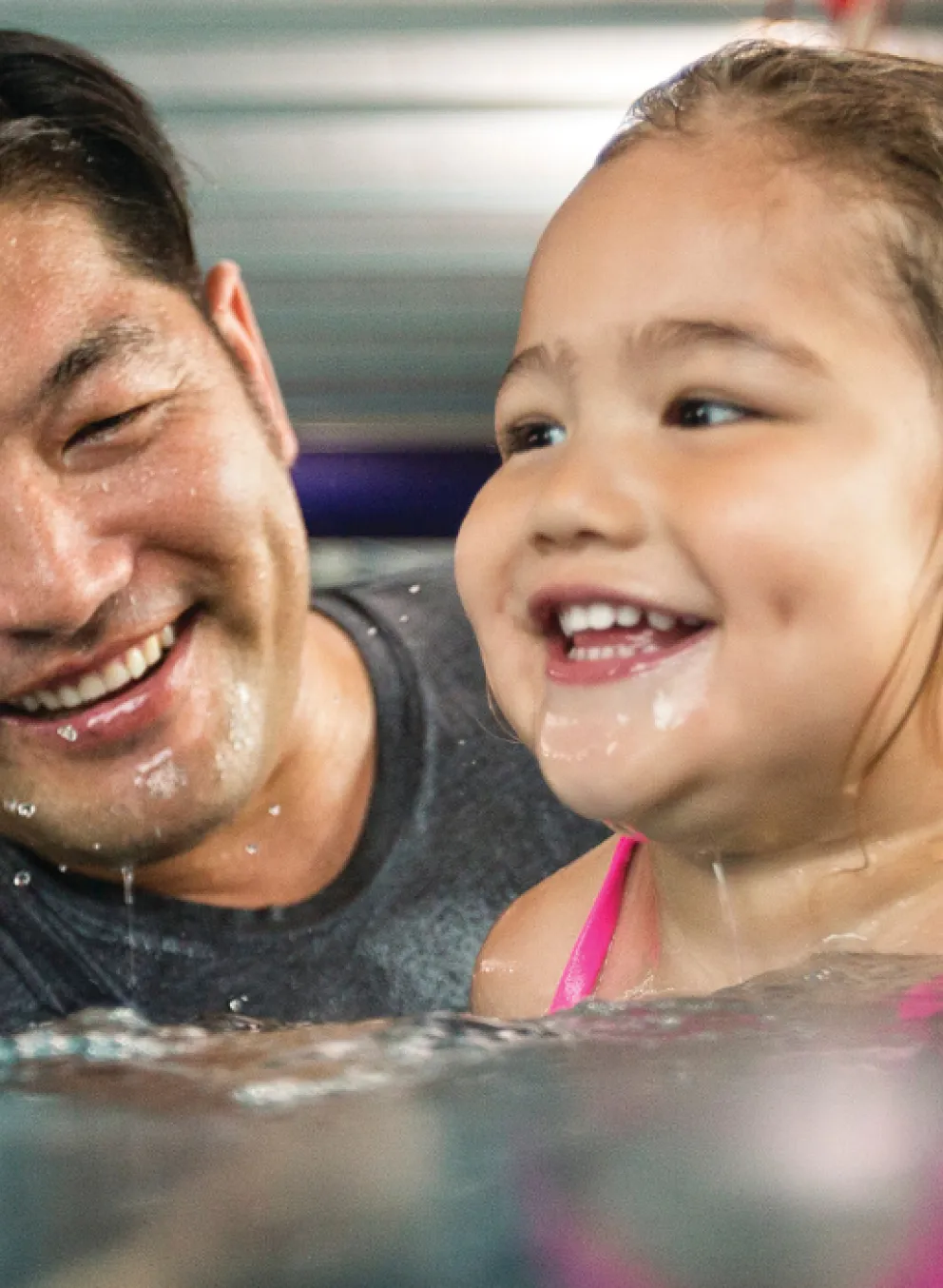 image of father helping young daughter swim