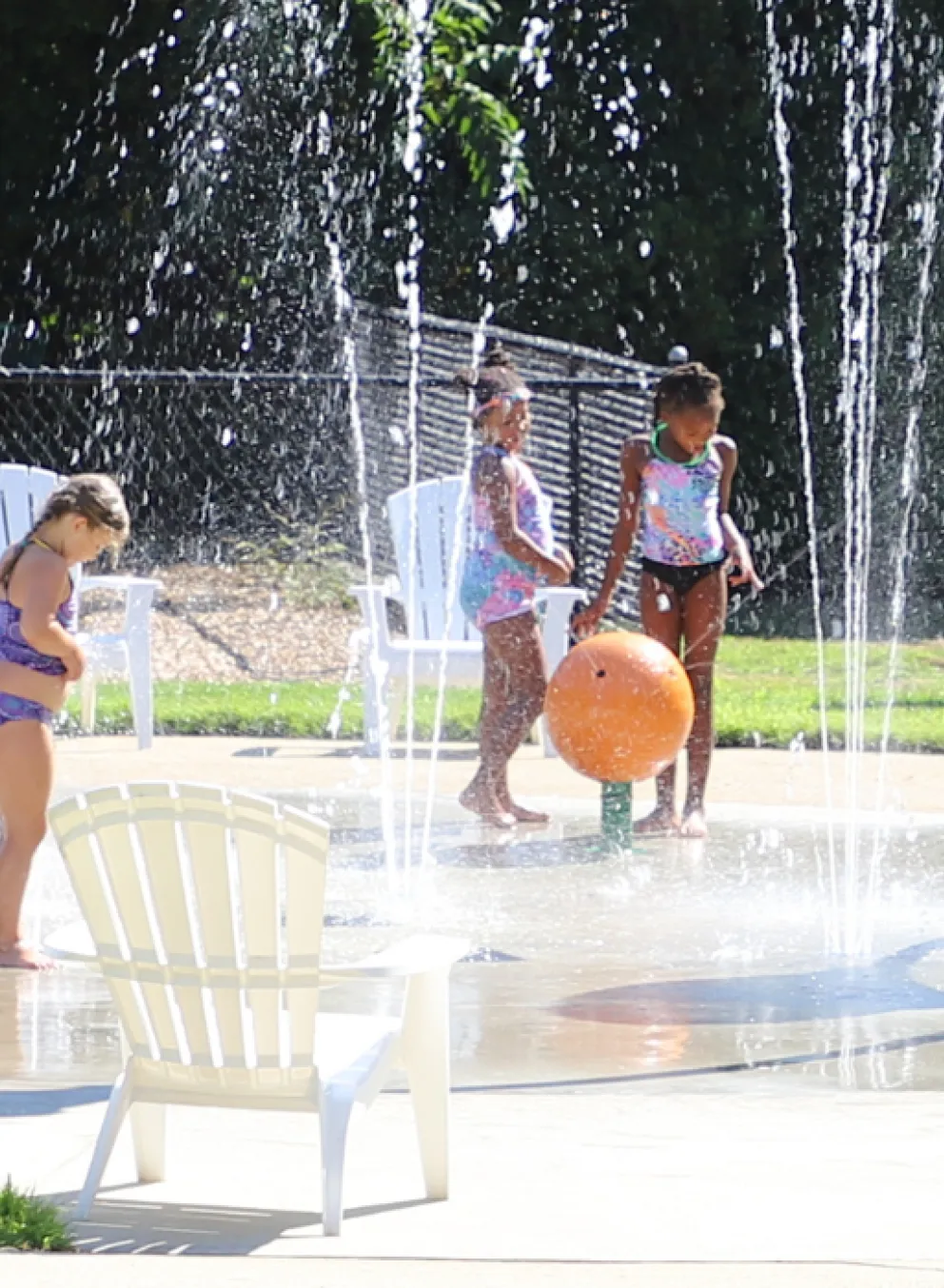 image of kids playing outside in the splash pad