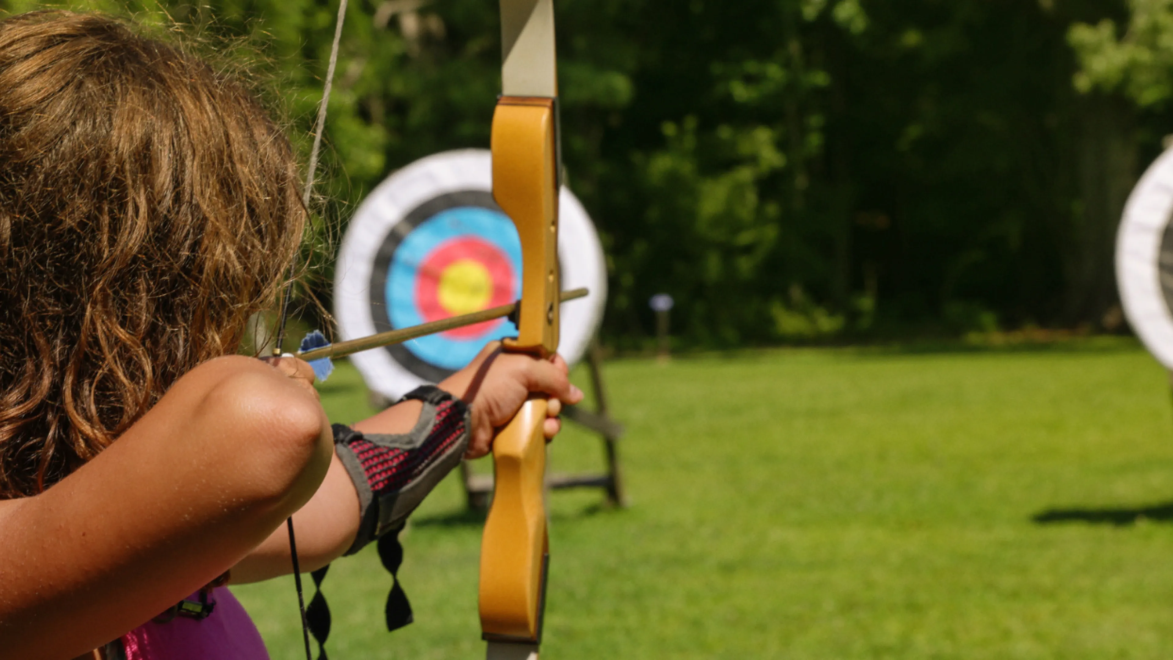 close-up of girl at archery range