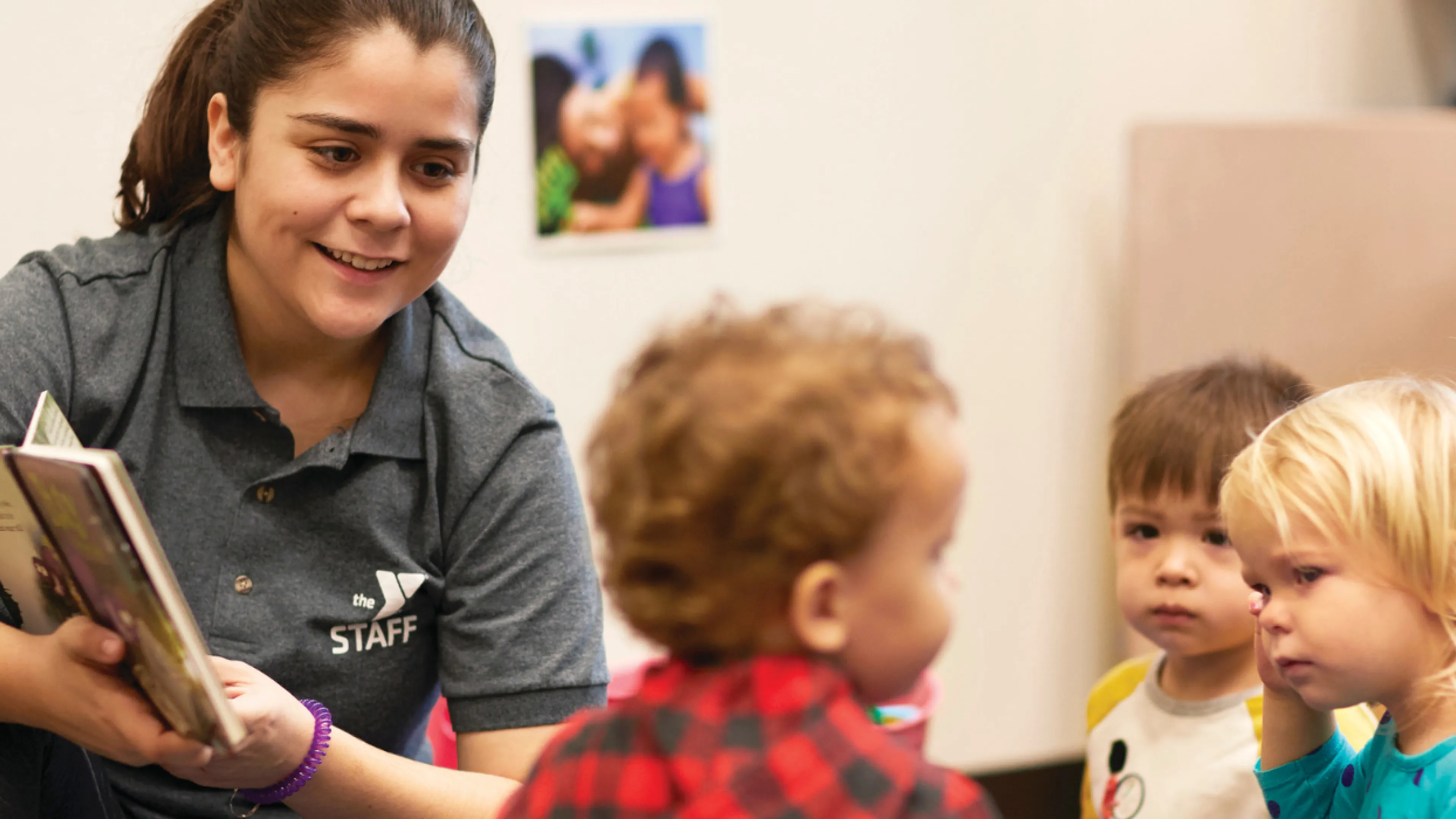 image of teacher reading to toddlers