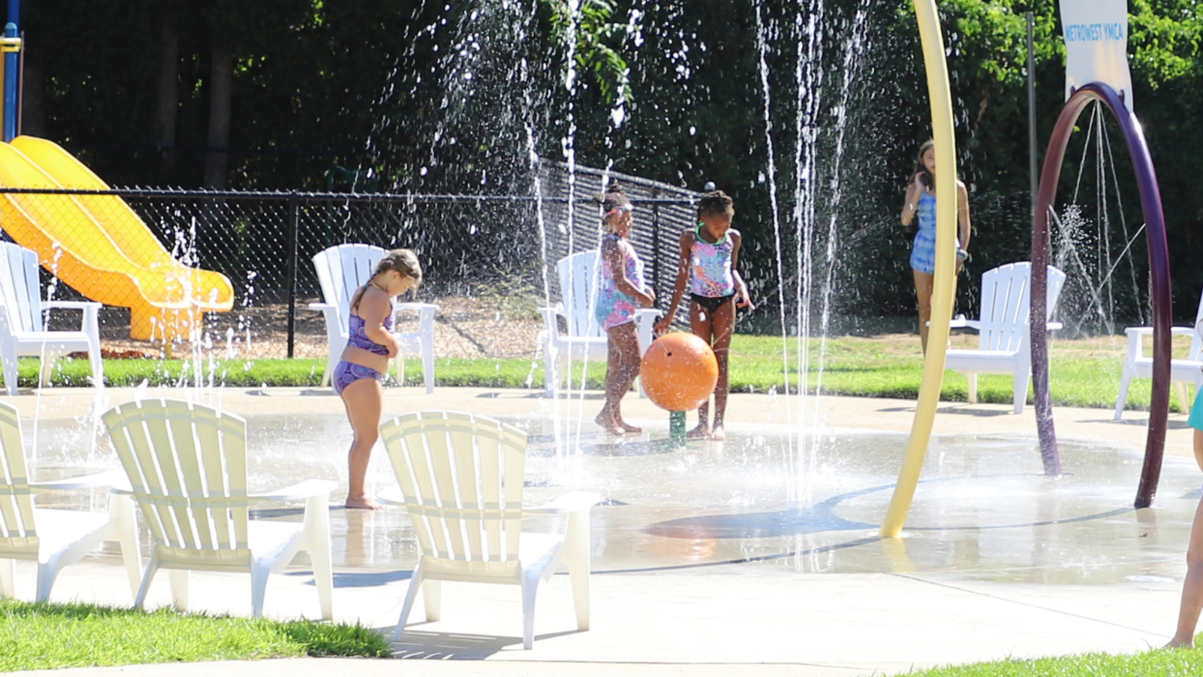 image of kids playing outside in the splash pad