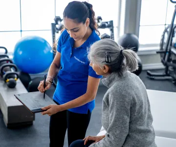 Trainer reviews fitness assessment data with client