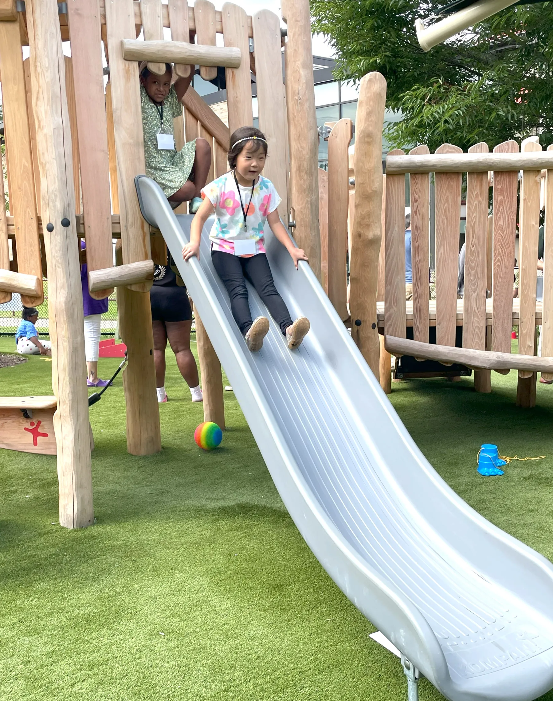 photo of a young girl going down the slide