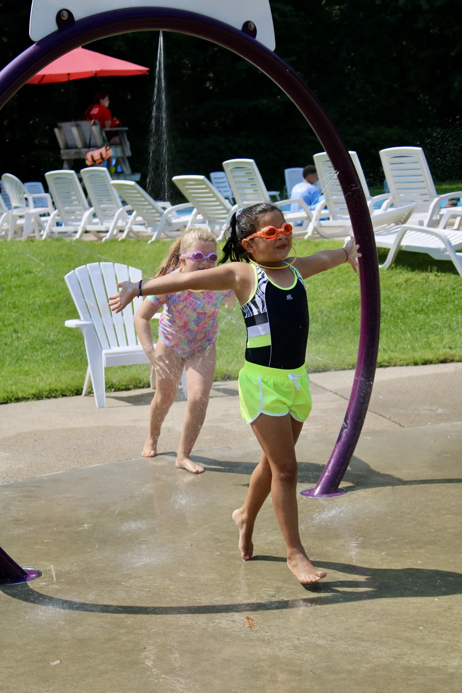 image of girl running through splash pad