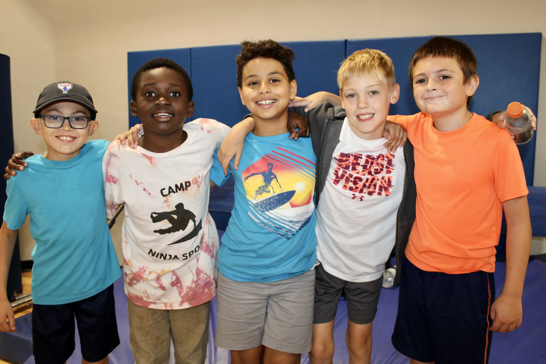 group photo of five boys smiling for the camera