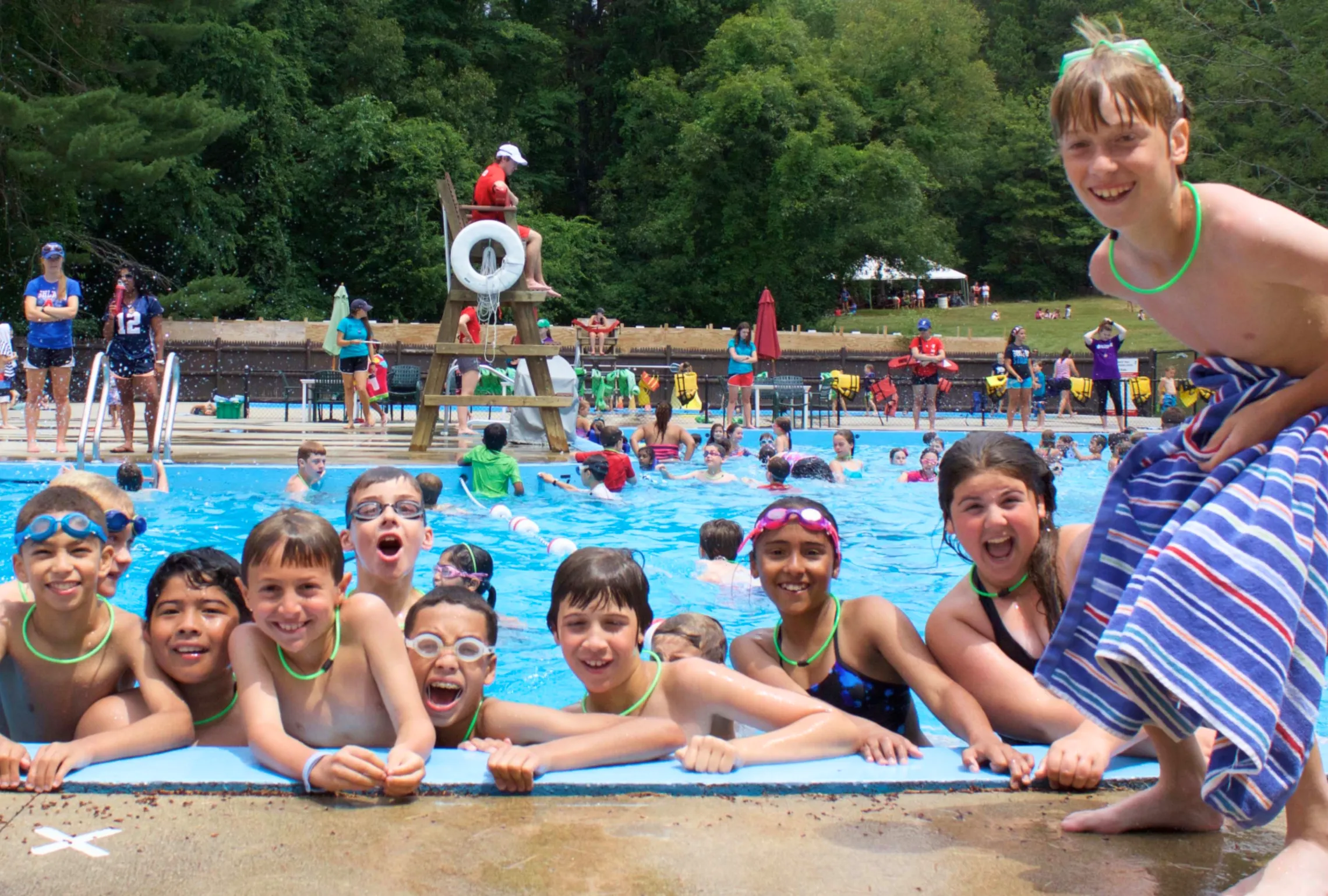 kids smile for the camera at pool