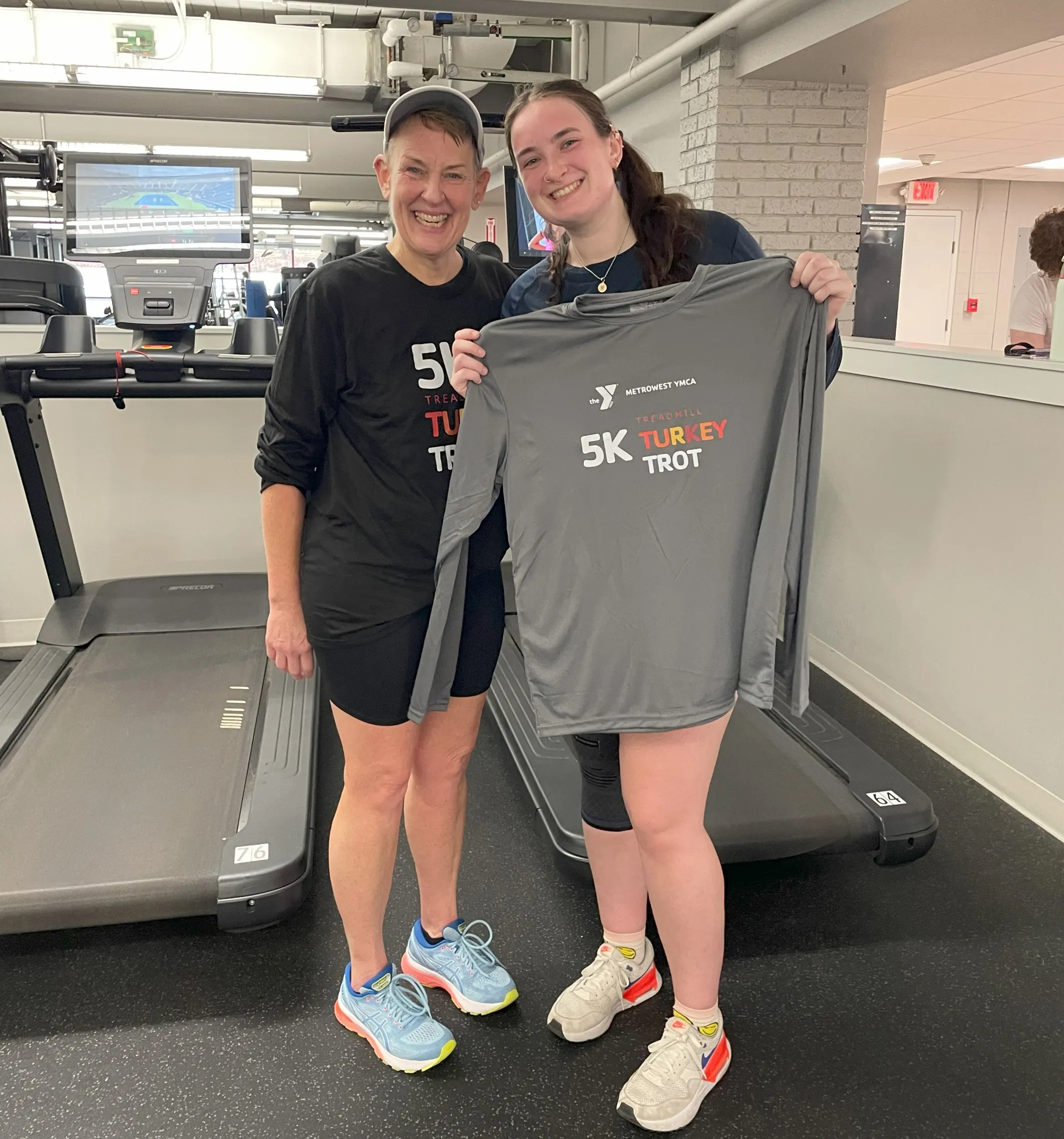 image of mother daughter standing in front of treadmills