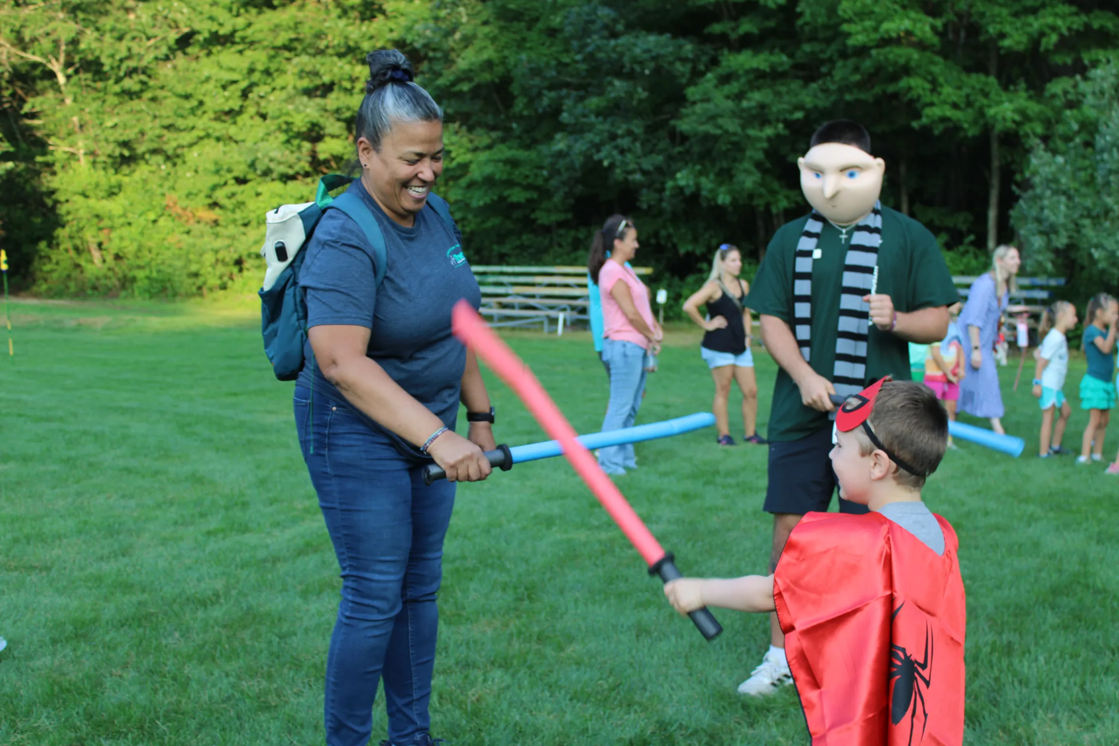 image of parent and child playing with lightsabers