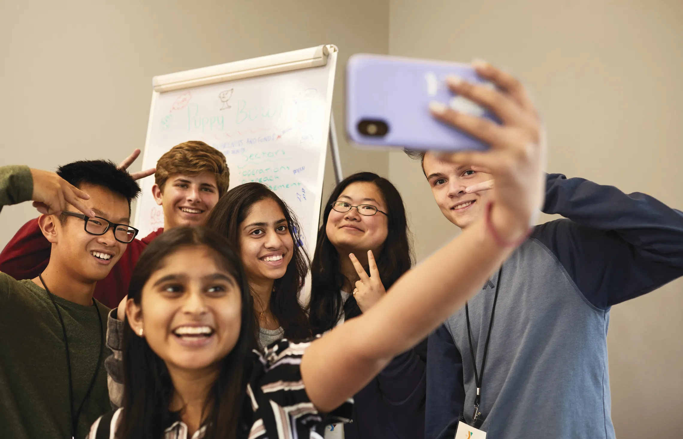 group of youth posing together to take a selfie
