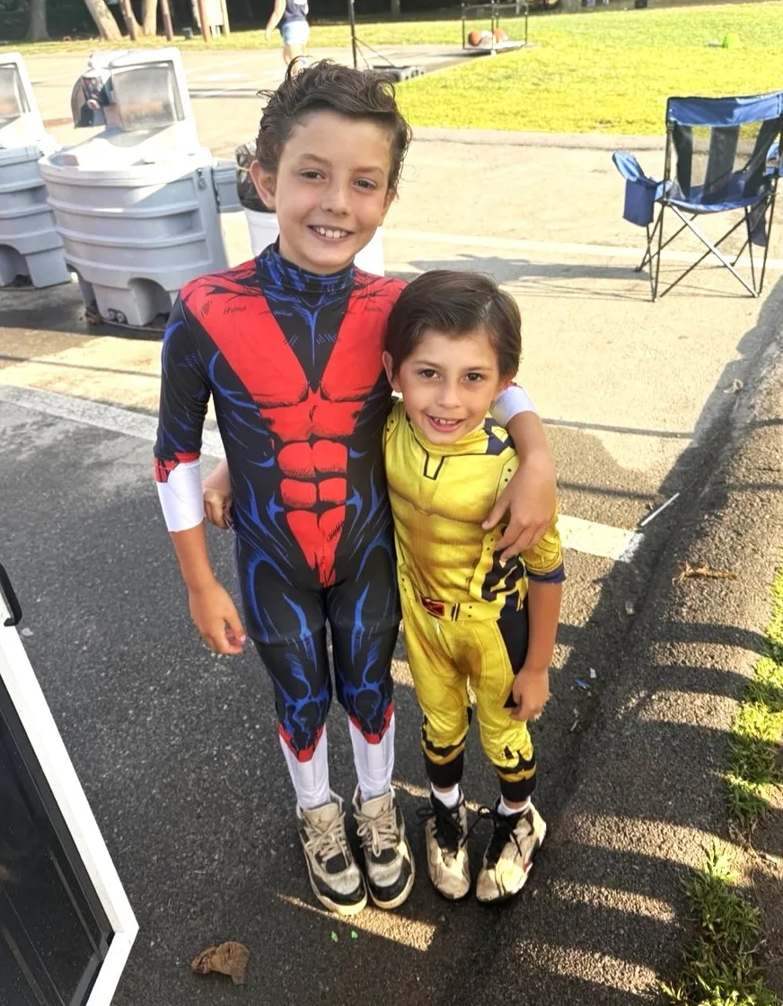 two boys at camp dressed up in superhero costumes