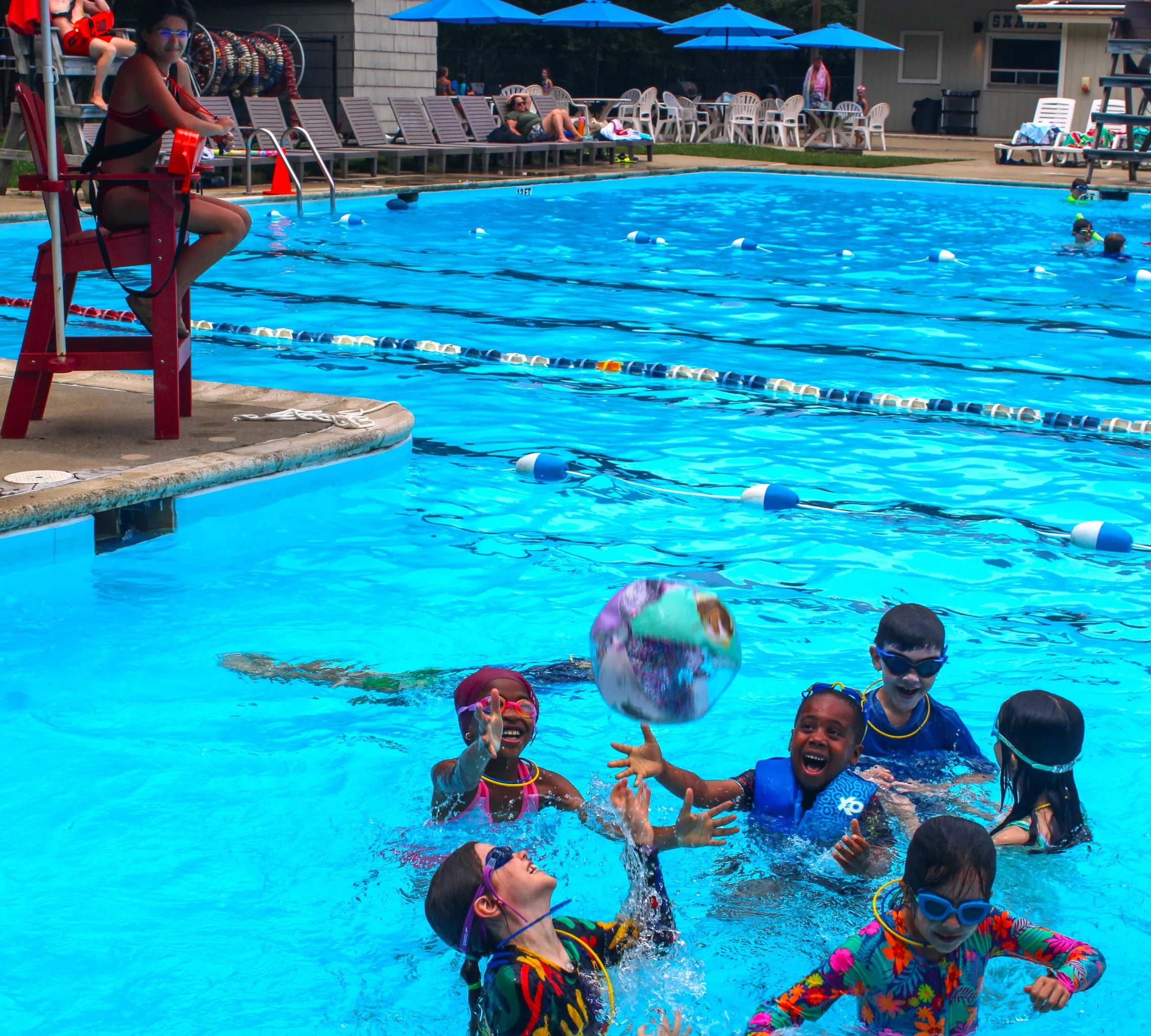 campers playing with beach ball in the pool