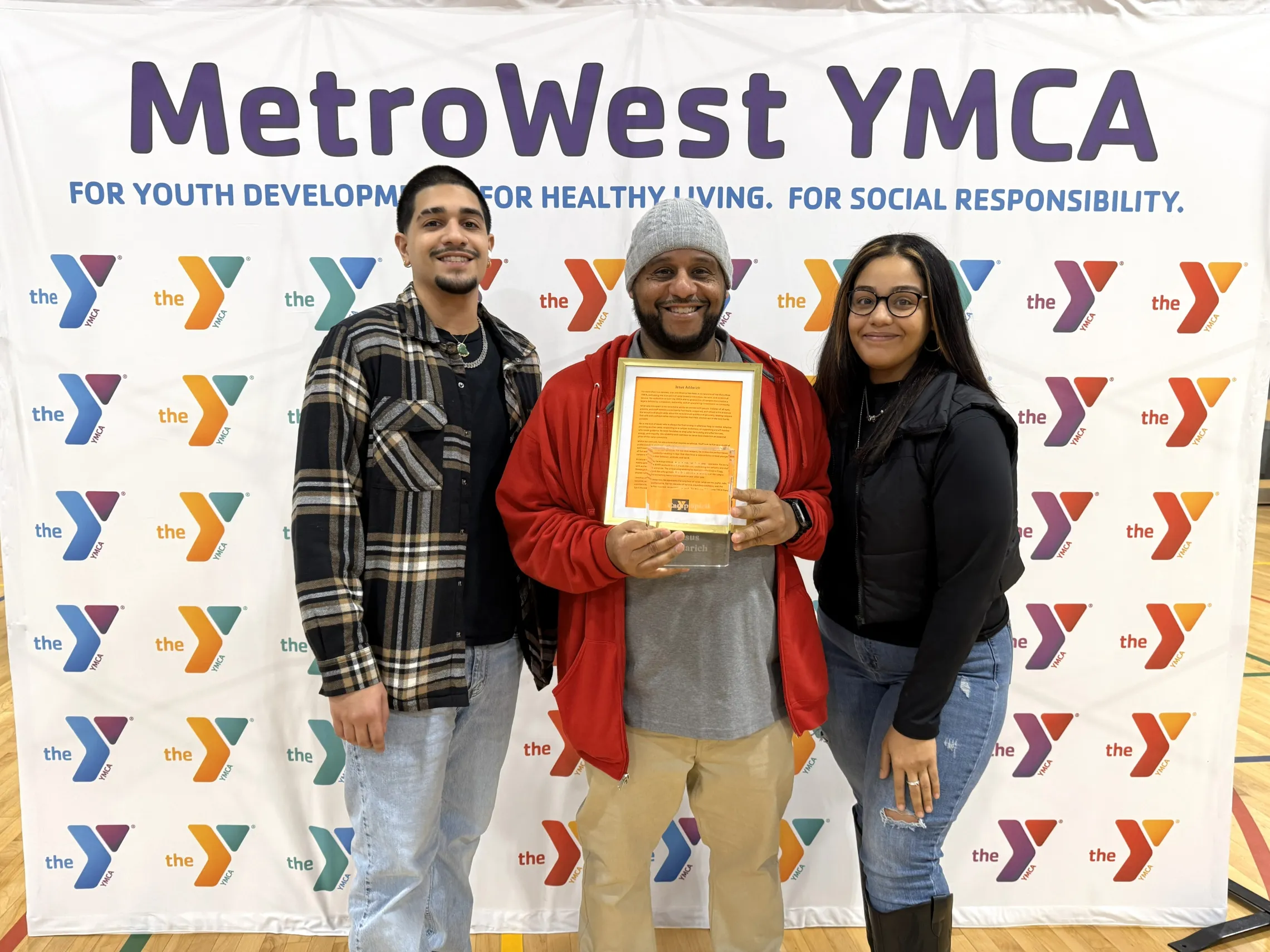 camp staff member posing for photo with family members