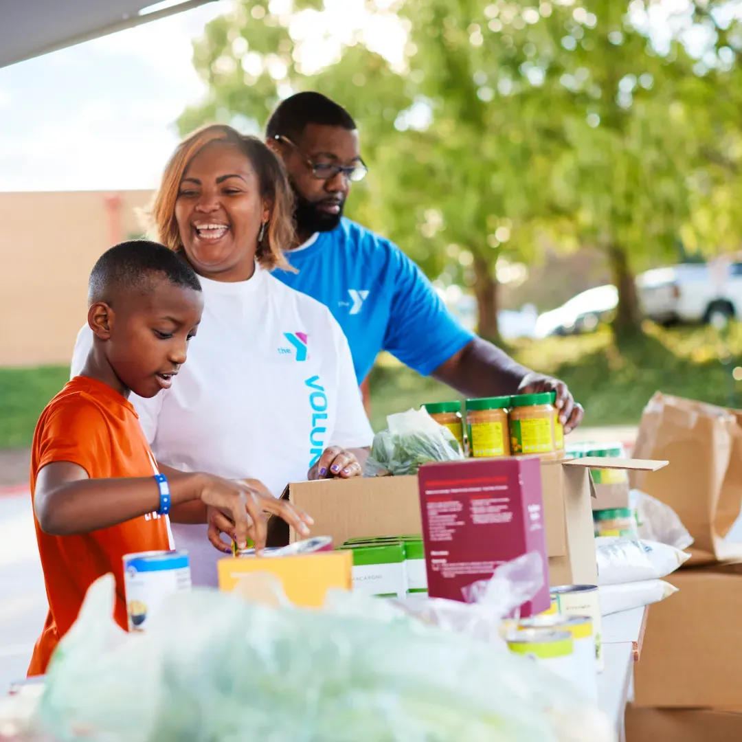 family volunteering at food drive