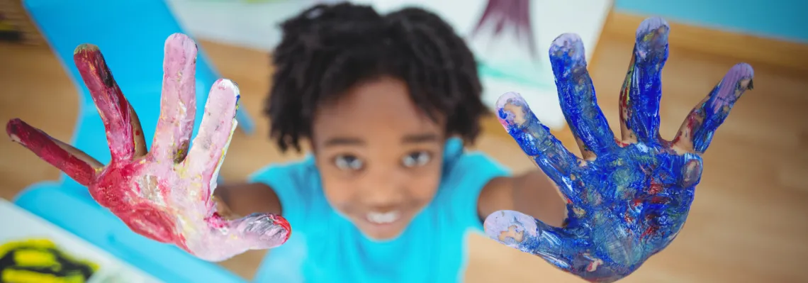 young boy with paint on his hands