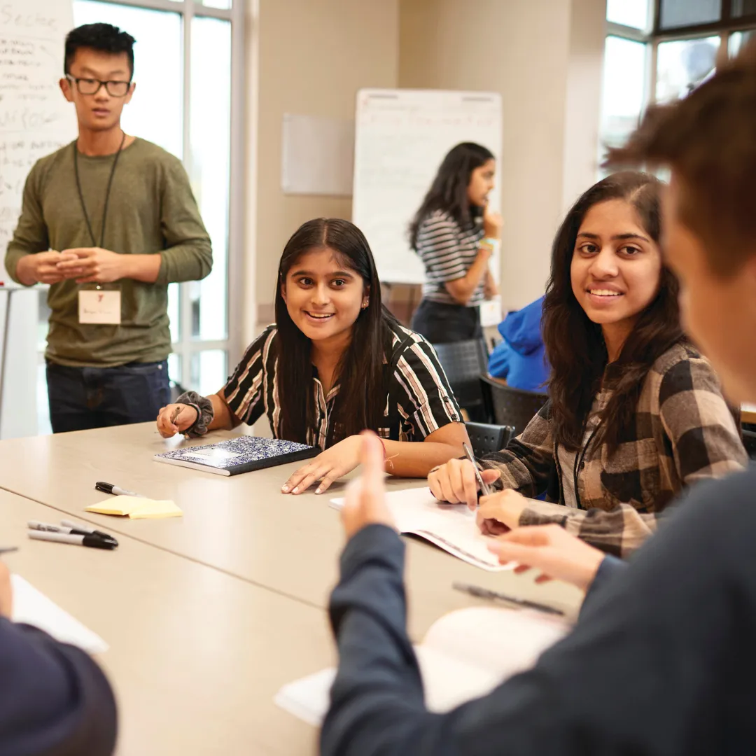 teens sitting at table learning together