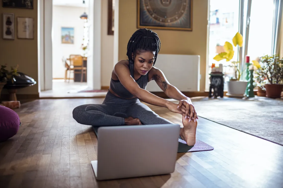 woman at home taking a virtual fitness class