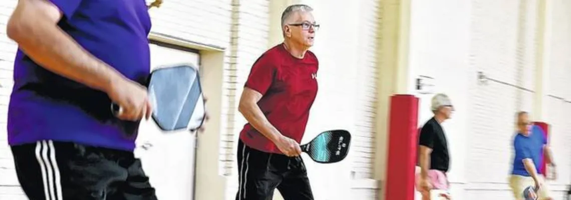 adult men playing indoor pickleball