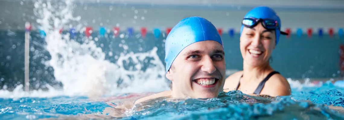 two adults swimming in pool