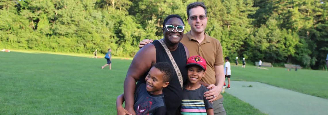 family of four smiling together