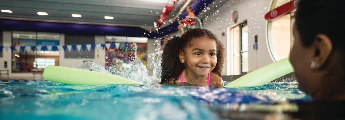 young girl learning how to swim