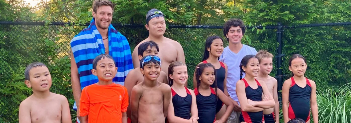 swim team posing together smiling