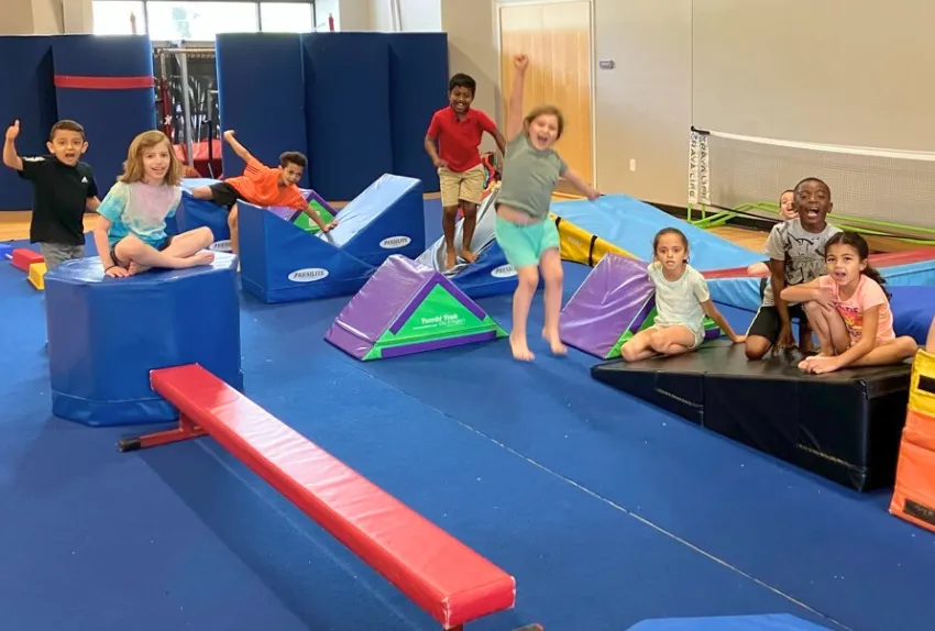 group of kids on gymnastics obstacle course